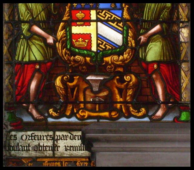 Stained Glass Window with Coat of Arms with Supporters over anvil and hammer.